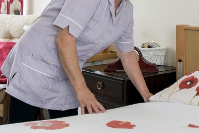 staff cleaning bedroom