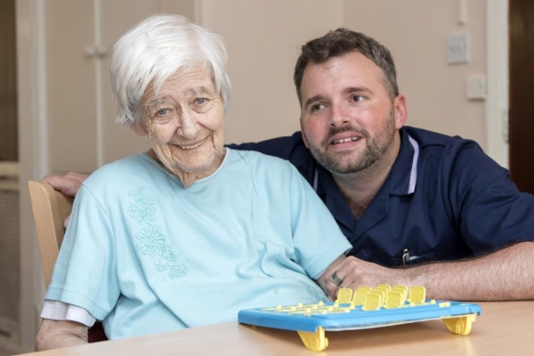 resident doing board game activity