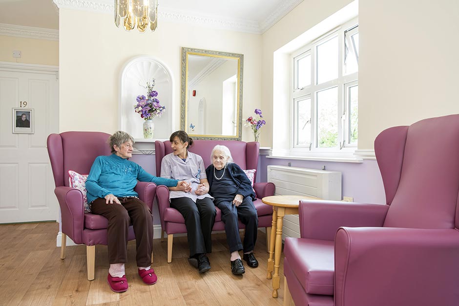 Small lounge carer talking with residents